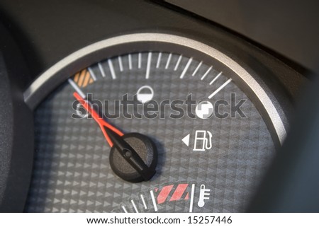 Closeup of a gas gage displaying that the car has an empty tank.  Shallow depth of field.