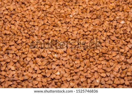 Background texture of whole grains of buckwheat. Image food product porridge buckwheat grains. Soft selective focus.