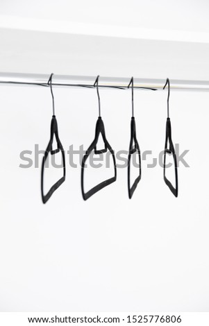 black hanger in a white cupboard