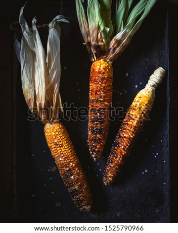 Roasted corn on dark background. Flat lay picture. Vertical view