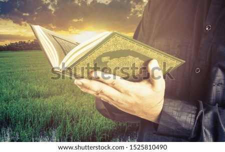 Koran in hand - holy book of Muslims ( public item of all muslims ) .