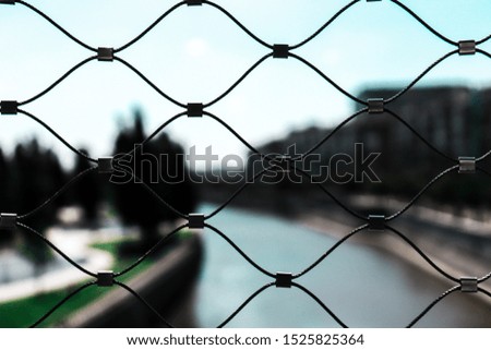
Macro photo of a fence, city in the background