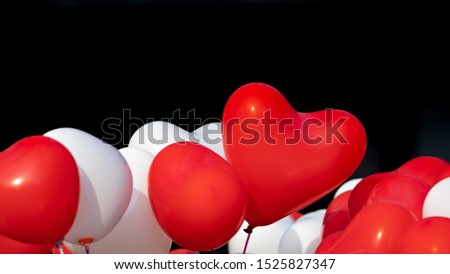 Group of Red and white Heart balloons isolated on black background, Holiday celebration, Valentine's Day party decoration.  