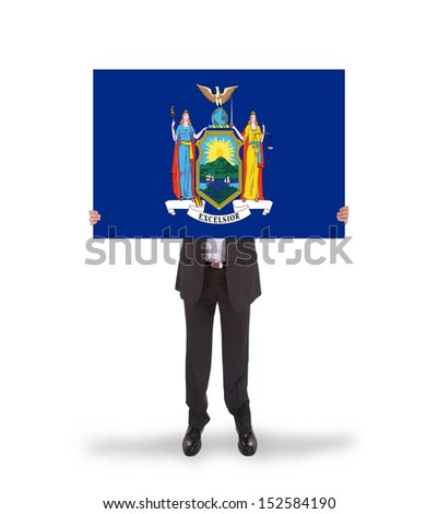 Smiling businessman holding a big card, flag of New York, isolated on white