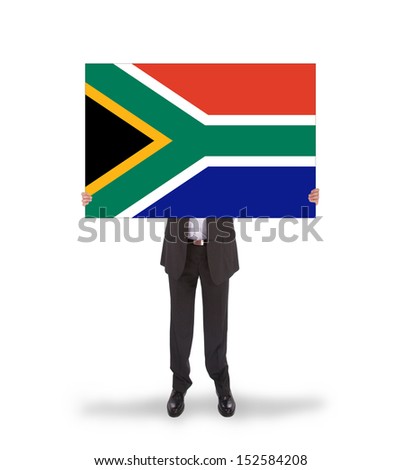 Smiling businessman holding a big card, flag of South Africa, isolated on white