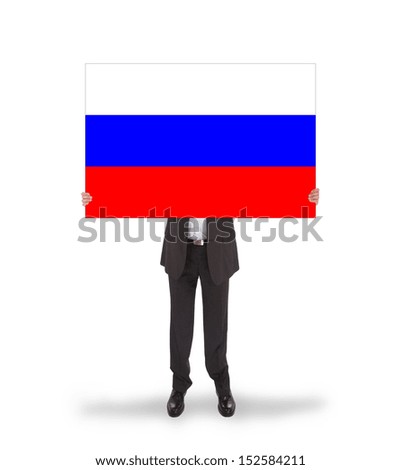 Smiling businessman holding a big card, flag of Russia, isolated on white