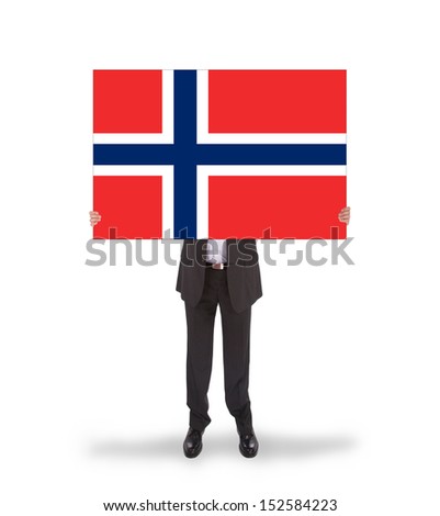 Smiling businessman holding a big card, flag of Norway, isolated on white