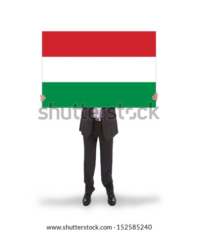 Smiling businessman holding a big card, flag of Hungary, isolated on white