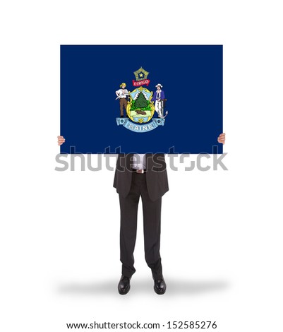 Smiling businessman holding a big card, flag of Maine, isolated on white