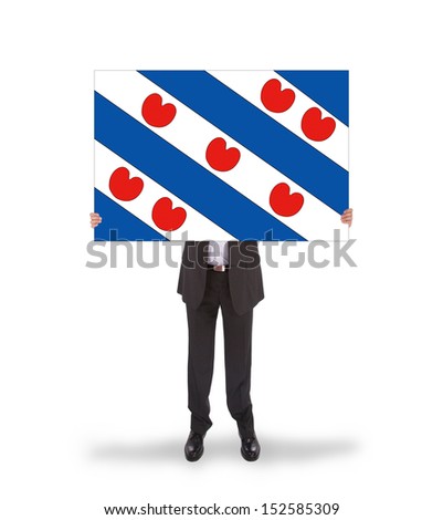 Smiling businessman holding a big card, flag of the dutch province of Friesland, isolated on white