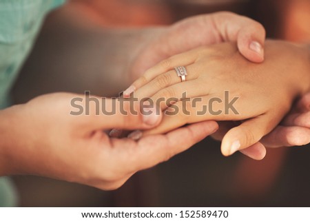 Wedding rings. Man giving an engagement ring to his girlfriend. Boyfriend Surprised Her Girlfriend With Engagement Ring In Restaurant
