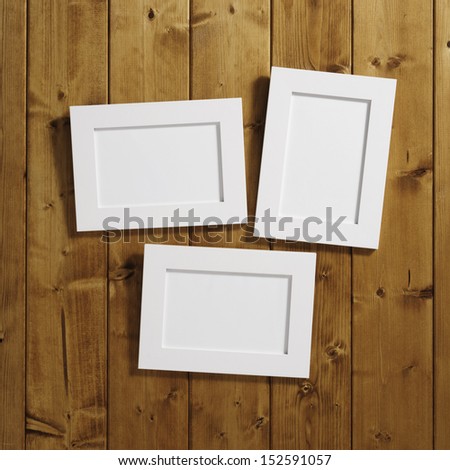 three frames on wooden wall