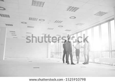 Black and white photo of business people on meeting in new empty office