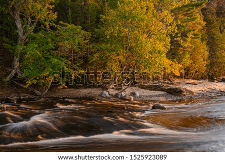 Autumn color change has jusdt started but the Hi=urricane River is in a hurry to meet the Lake Superior shore just feet away, Pictured Rocks National Lakeshore, Alger County, Michigan