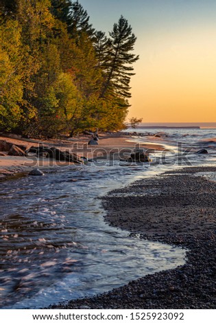 The Huricane River rushes to meet the Lake Superior shore at sunset on an autumn evening, Piictured Rocks National Lakeshore, Alger County, Michigan