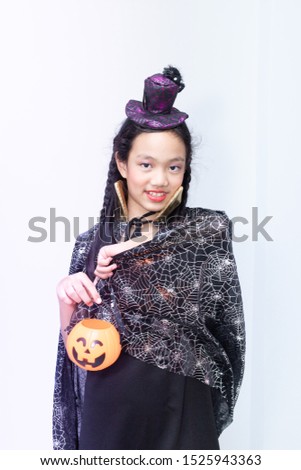 Girl with halloween costumes on white background.