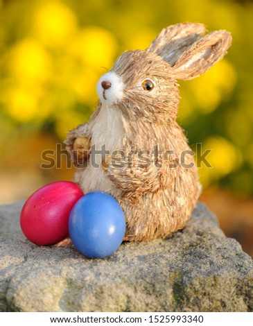 Easter bunny figure with brightly coloured Easter eggs
