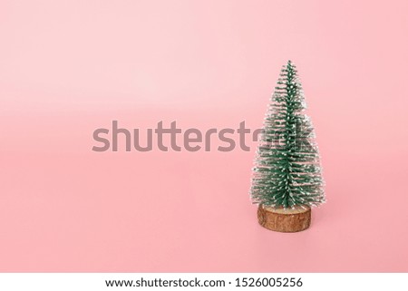 Christmas tree made in pink background with copy space for text. Minimal xmas concept. New year 2020 celebration. Mockup, template, greeting card