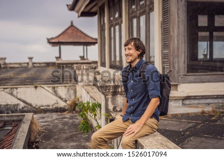 Man tourist in abandoned and mysterious hotel in Bedugul. Indonesia, Bali Island. 