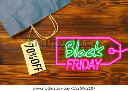 Paper bag on wooden  background with sale tag .  Black friday sale- Image 