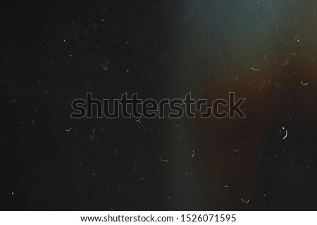 Black abstract background. The effect of the old film photography. 90s. Lens flare. Heavy grain texture