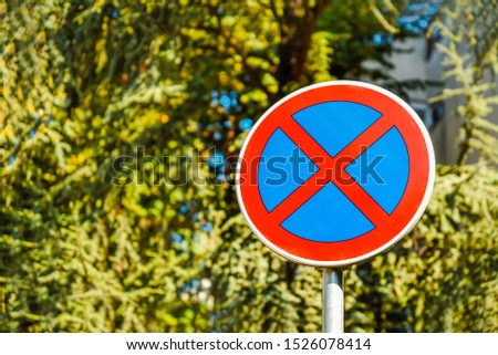 No Stopping and No parking sign on tree background
