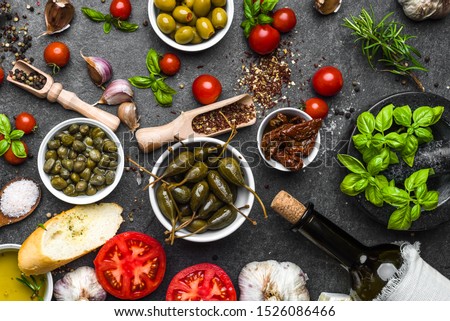 Mediterranean diet background. Cooking ingredients on dark slate. Royalty-Free Stock Photo #1526086466