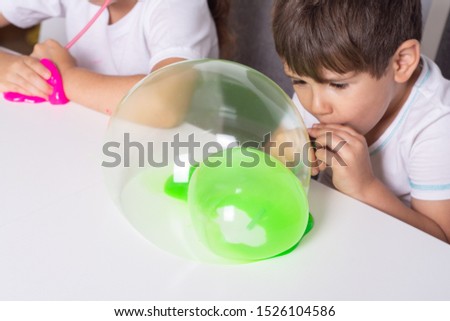 Kids making bubbles slime. Kid playing with slime