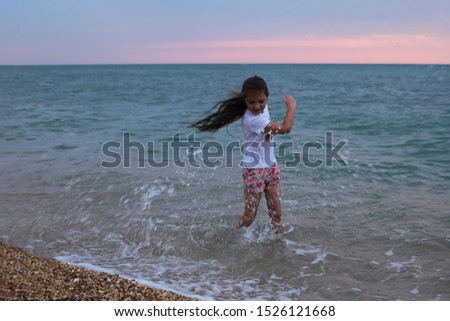 Girl with long hair by the sea