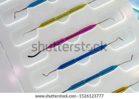 Tools for the periodontist.Scalers in stomatology.Multi-colored dental curettes. Curettes for dental fillings. Dental probes.Bilateral stomatologic probes. Dentistry. Dentist Tools.Dental equipment Royalty-Free Stock Photo #1526123777