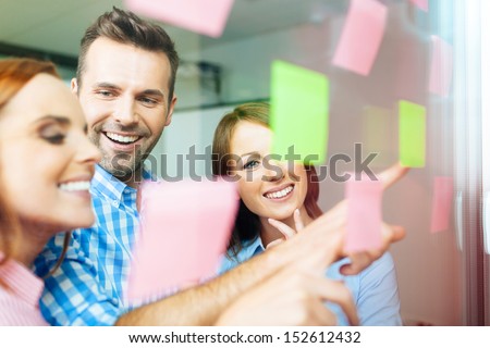 Group of business people working on new project with many sticky notes on window Royalty-Free Stock Photo #152612432