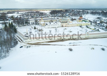 View of the Tikhvin Mother of God Assumption Monastery on a gloomy March day (aerial photography). Tikhvin, Leningrad Region