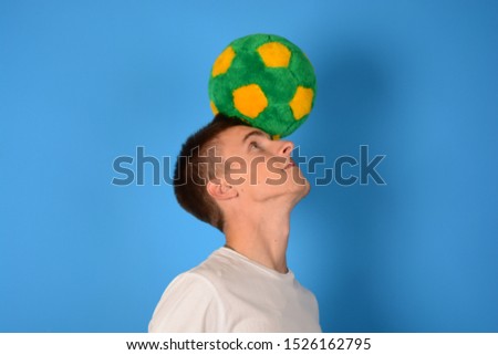 soccer player ball on his head on a blue background sports