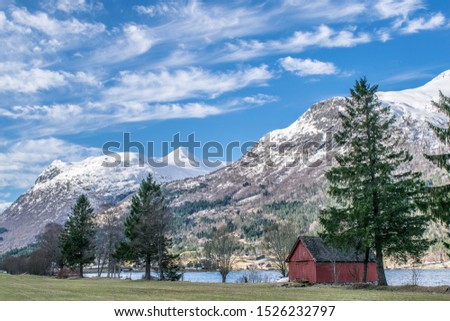Red boat house in spring landscape . Photo from Gjerane in Stryn , in Norway . 