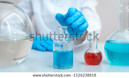 Panoramic view and cropped photo of scientist woman making laboratory analysis, searching vaccine solution, choosing medical glass bottles with liquid, sitting in workspace office