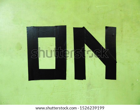 the words "ON" are black on the wall.