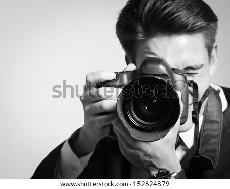 Young man using a professional camera Royalty-Free Stock Photo #152624879