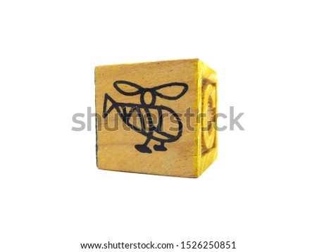 Closeup of wooden alphabet block toy on white background.