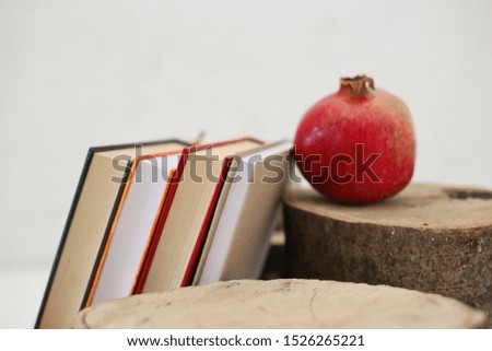 Autumn fruits and books on white background