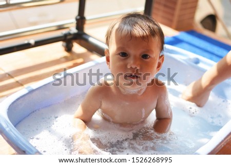close up,a boy playing in the bath