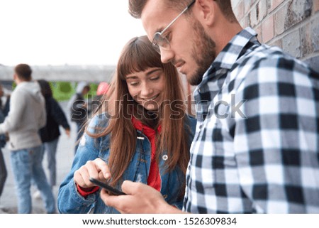 Young couple looking at mobile phone 
