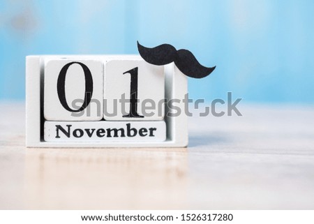 1 November Calendar and mustache on wood table background. Father, International men day, Prostate Cancer Awareness and World cancer day concept