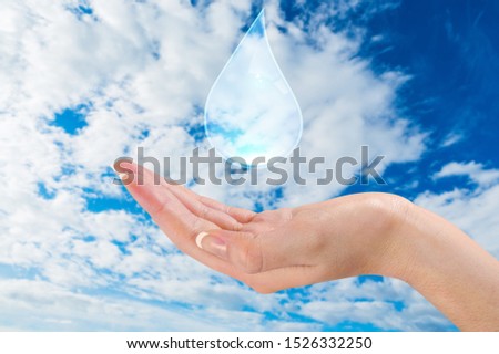Clouds shaped like drops ozone of water in woman hands on blue sky background