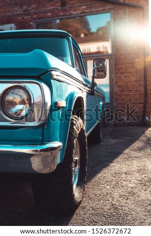 Old american car in front of a brick building