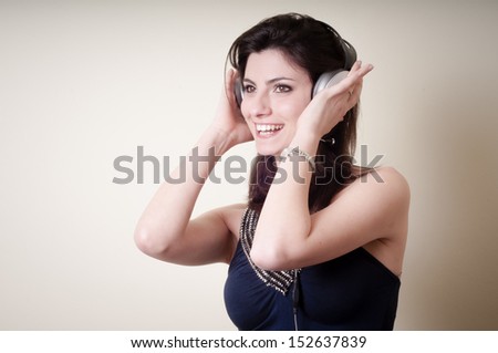beautiful young woman listening to music on white background