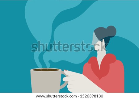 Woman holds a cup of steaming hot coffee 