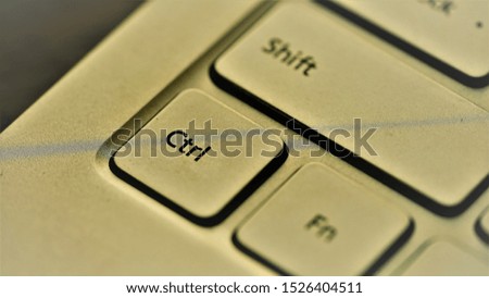 Close up view on Ctrl button on brown metallic keyboard 