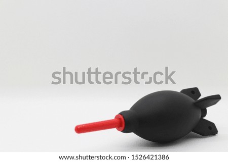 Black rubber blower with red head for cleaning photographic equipment  on the White Blackground