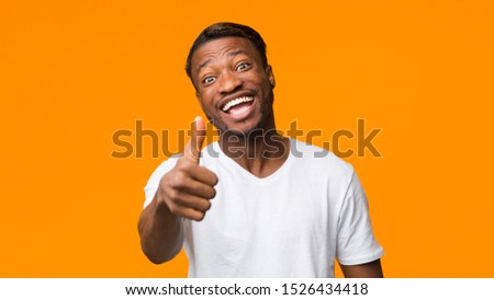 Like. Funny African American Man Gesturing Thumbs Up Standing On Orange Background In Studio. Panorama, Selective Focus