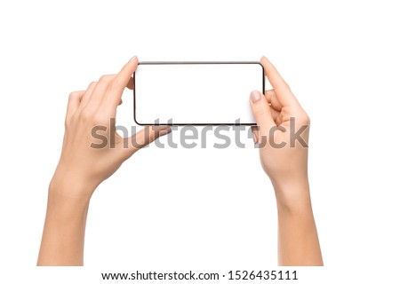 Female hands holding smartphone with blank screen taking photo, isolated on white background, free space Royalty-Free Stock Photo #1526435111